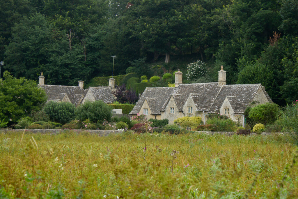 A beautiful view of one of the Cotswold Villages across a water meadow